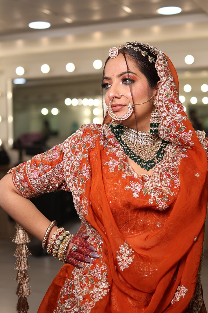 Pankhuri in a richly embroidered red lehenga, looking aside