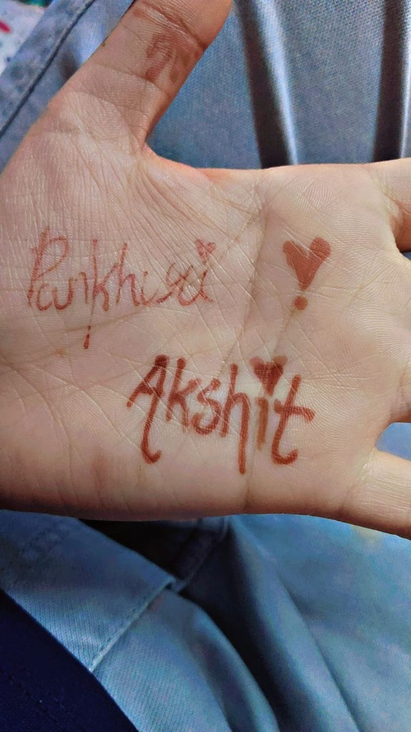 Palm with the names Pankhuri and Akshit written in henna