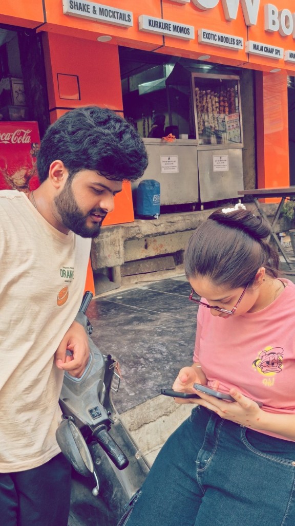 Pankhuri and Akshit together on a city street
